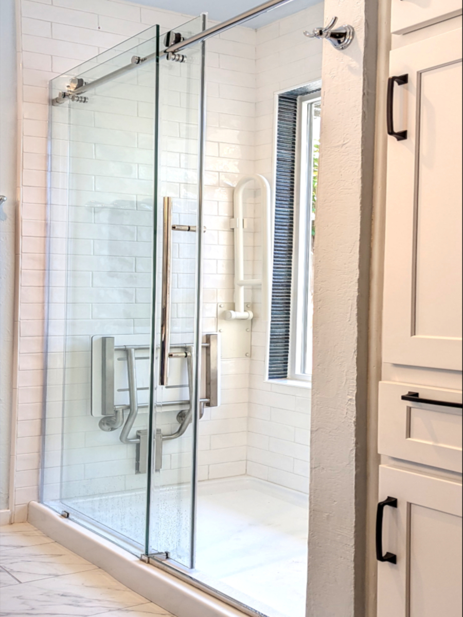 Bathroom remodel shower with glass sliding door, shower pan, white and blue tile