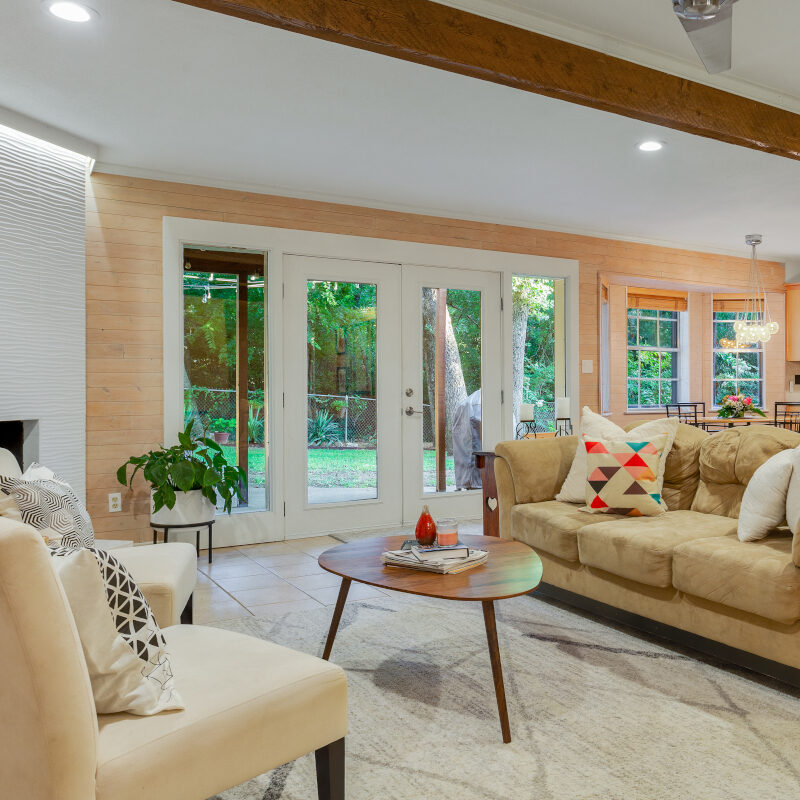 Contemporary living room with white washed walls and sculptural white fireplace