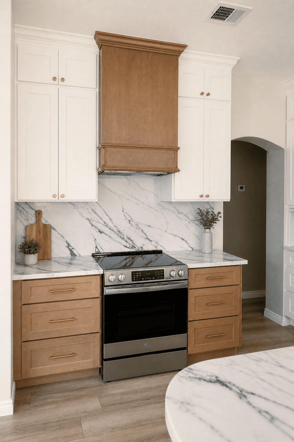 Transitional_Kitchen_Stone_Backsplash_Wood_Hood View of kitchen stove and cabinets with a wood vent hood